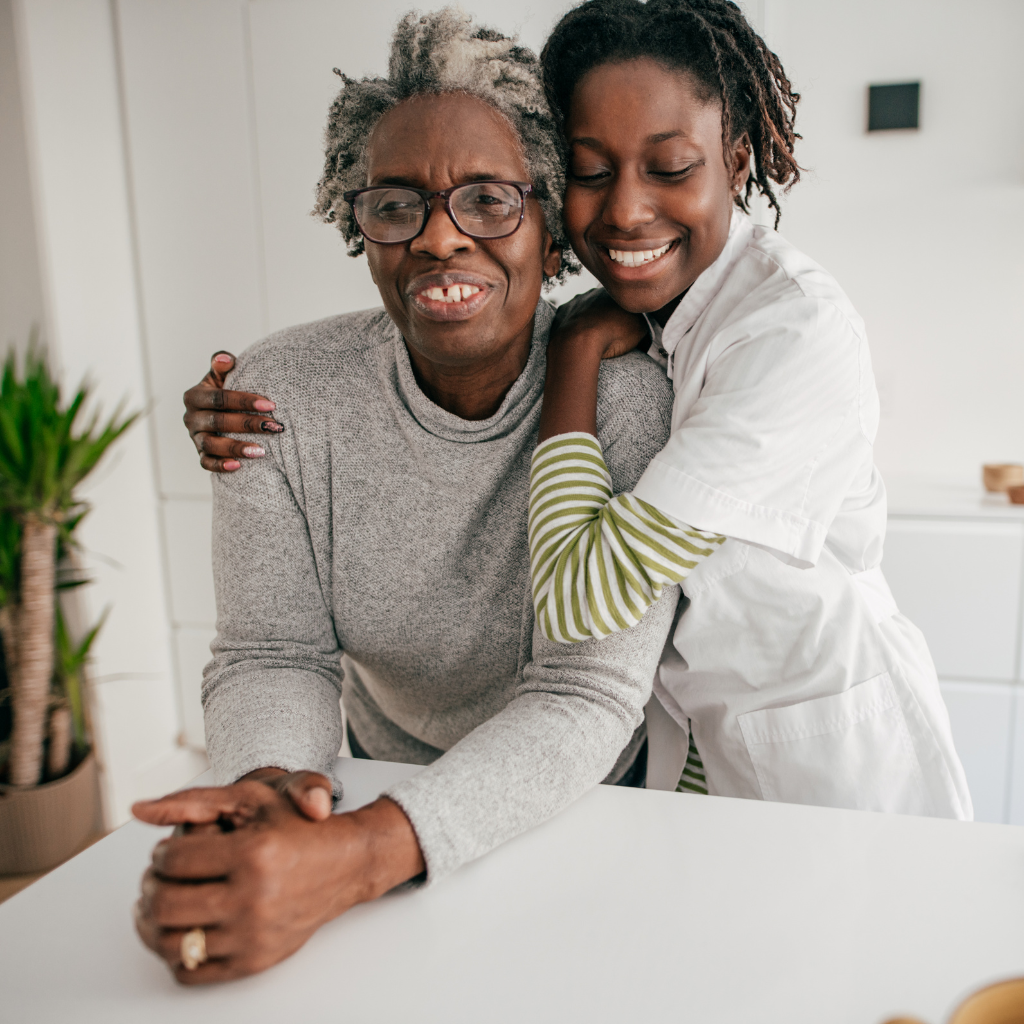 A caregiver sitting with an older adult during a home visit