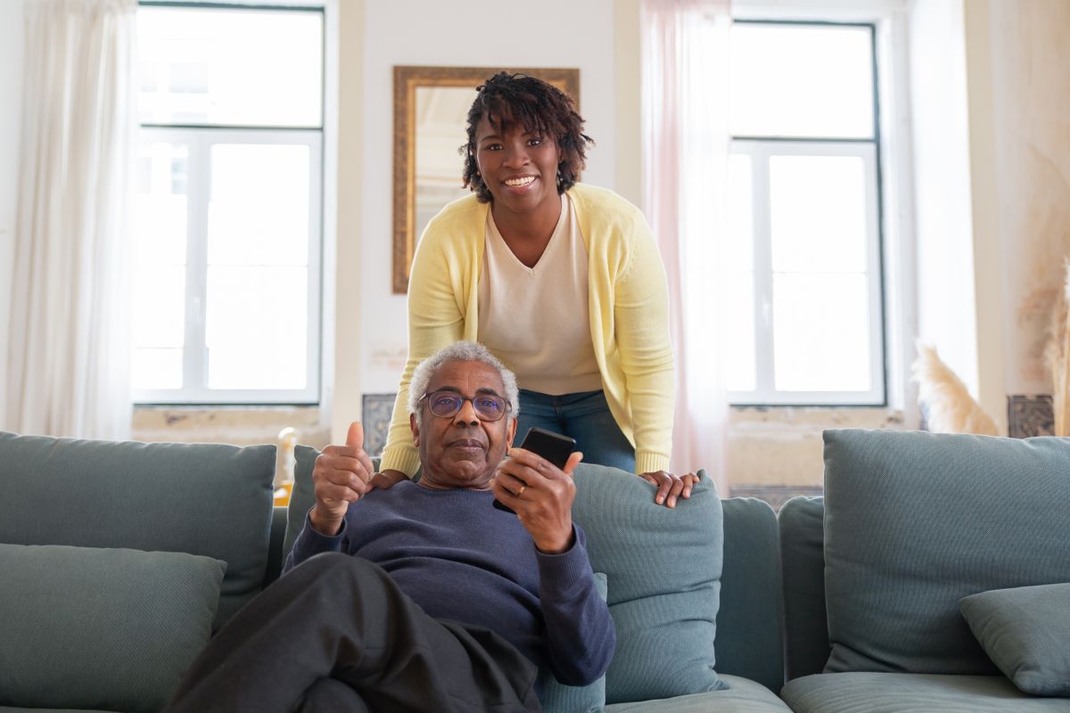 A calm companion sitting with an older adult during a home visit