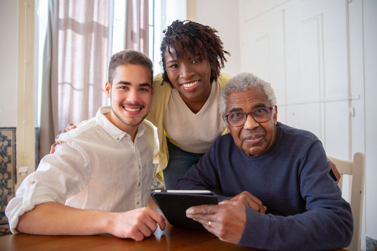 A caregiver offering personal support to an older adult at home